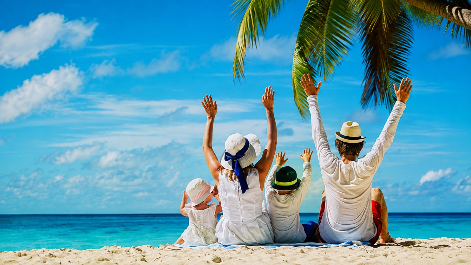 Family enjoying a beach holiday planned by StarLux Travel Services